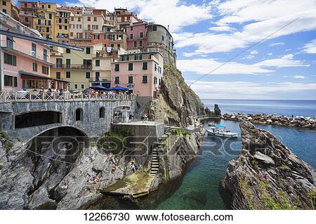 A view of Manarola with clear blue ocean and colourful buildings; Manarola, Liguria, Italy View Large Photo Image Stock Image - A view of Manarola with clear blue ocean and colourful buildings; Manarola, Liguria, Italy. Fotosearch