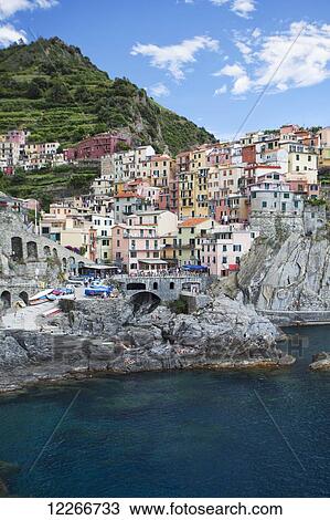 A view of Manarola with clear blue ocean and colourful buildings; Manarola, Liguria, Italy View Large Photo Image Stock Image - A view of Manarola with clear blue ocean and colourful buildings; Manarola, Liguria, Italy. Fotosearch