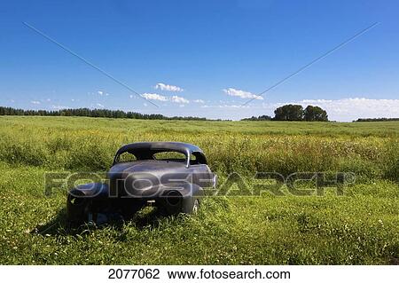Stock Image - A Vintage Car Abandoned In A Field; Parkland County Alberta Canada. Fotosearch