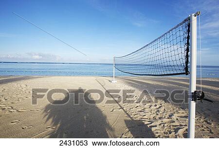Stock Image - A volleyball net on a white sand beach; Mauritius. Fotosearch
