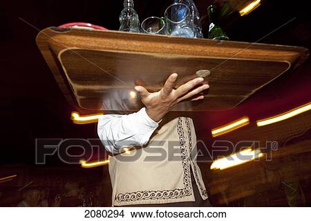 Picture - A Waiter Serving Drinks Under A Tent In A Recreated Berber Village; Tunisia, North Africa. Fotosearch