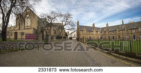 Stock Image - A Walkway Leading Towards A Church And Residential Buildings; Sunderland, Tyne And Wear, England. Fotosearch