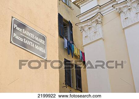 Stock Image - A washing line full of colourful clothes in the Terra Nova district of Bastia. Corsica. France.. Fotosearch