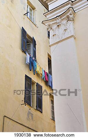 A washing line full of colourful clothes in the Terra Nova district of Bastia. Corsica. France. View Large Photo Image Stock Photo - A washing line full of colourful clothes in the Terra Nova district of Bastia. Corsica. France.. Fotosearch