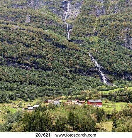 A Waterfall Down The Mountainside With Houses In The Valley; Undredal Sognefjord Norway View Large Photo Image Stock Image - A Waterfall Down The Mountainside With Houses In The Valley; Undredal Sognefjord Norway. Fotosearch