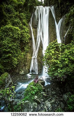 A waterfall on Tanna Island with a man in traditional costume in the foreground; Tanna Island, Vanuatu View Large Photo Image Stock Image - A waterfall on Tanna Island with a man in traditional costume in the foreground; Tanna Island, Vanuatu. Fotosearch