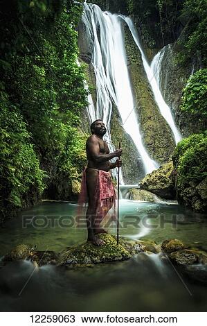 A waterfall on Tanna Island with a man in traditional costume in the foreground; Tanna Island, Vanuatu View Large Photo Image Stock Image - A waterfall on Tanna Island with a man in traditional costume in the foreground; Tanna Island, Vanuatu. Fotosearch