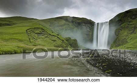 A Waterfall Over A Grassy Cliff; Skogarfoss Iceland View Large Photo Image Picture - A Waterfall Over A Grassy Cliff; Skogarfoss Iceland. Fotosearch