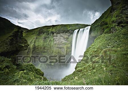 A Waterfall Over A Grassy Cliff; Skogarfoss Iceland View Large Photo Image Stock Photography - A Waterfall Over A Grassy Cliff; Skogarfoss Iceland. Fotosearch