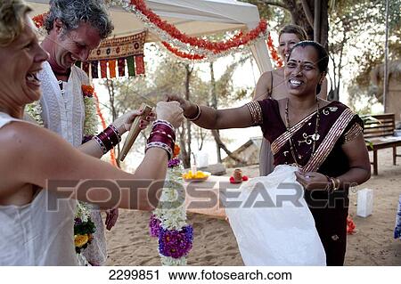Stock Image - A western couple have a spiritual wedding ceremony at Harmonic Healing Centre, Patnum, Goa, India.. Fotosearch