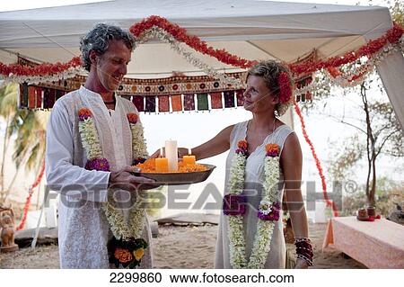 A western couple have a spiritual wedding ceremony at Harmonic Healing Centre, Patnum, Goa, India. View Large Photo Image Stock Image - A western couple have a spiritual wedding ceremony at Harmonic Healing Centre, Patnum, Goa, India.. Fotosearch