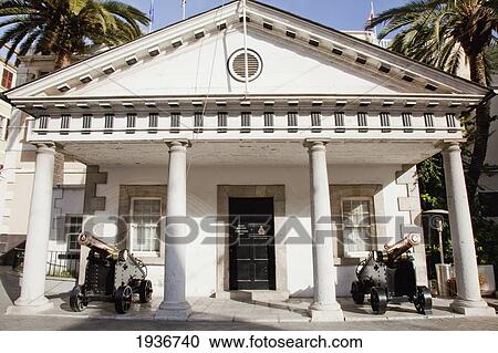 Stock Image - A White Building With Cannons Displayed Outside; Gibraltar. Fotosearch