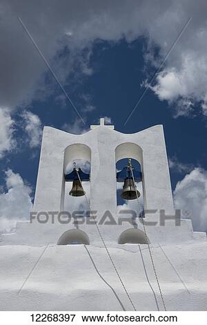 Stock Photo - A whitewashed bell tower and dramatic white clouds; Sifnos, Cyclades, Greek Islands, Greece. Fotosearch