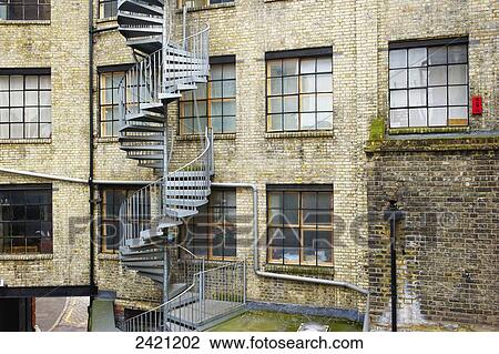 Stock Image - A winding stairway on the exterior of a residential brick building in Shoreditch; london, England. Fotosearch