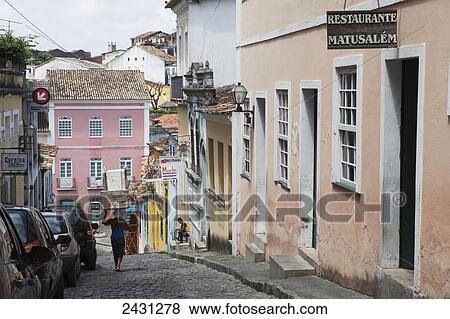 A woman carrying boxes on her head down a steep cobbled street in the Pelourinho historical centre of Salvador; Salvador, Brazil View Large Photo Image Stock Photo - A woman carrying boxes on her head down a steep cobbled street in the Pelourinho historical centre of Salvador; Salvador, Brazil. Fotosearch