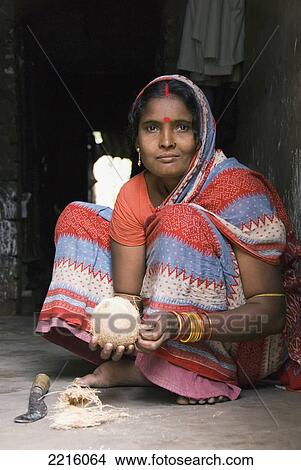 A Woman Carving A Coconut In Raghurajpur, Orissa, India View Large Photo Image Picture - A Woman Carving A Coconut In Raghurajpur, Orissa, India. Fotosearch
