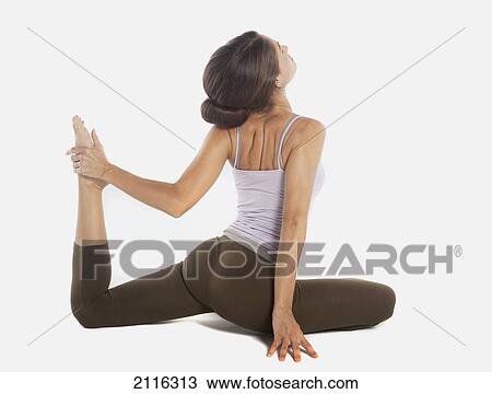 A woman does Yoga poses in a studio, white background. View Large Photo Image Stock Image - A woman does Yoga poses in a studio, white background.. Fotosearch