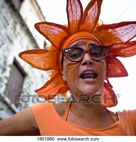 Stock Image - A Woman Dressed Up As An Orange Flower. Fotosearch