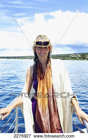 A woman enjoys a leisure boat ride off the coast of an hawaiian island; Hawaii, United States of America View Large Photo Image Stock Photo - A woman enjoys a leisure boat ride off the coast of an hawaiian island; Hawaii, United States of America. Fotosearch