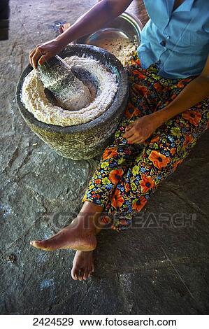 Stock Photo - A woman grinding wheat; Ulpotha, Embogama, Sri Lanka. Fotosearch