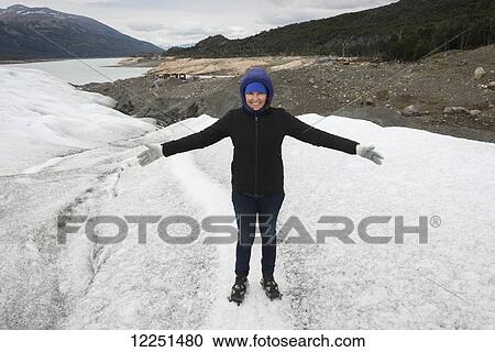 Stock Image - A woman hiking on Moreno glacier, Los Glaciares National Park; Santa Cruz Province, Argentina. Fotosearch