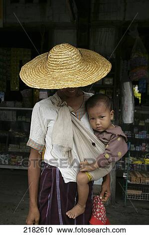 A woman holding a young child, New Nyein pottery village on the Irrawaddy River; Myanmar View Large Photo Image Stock Image - A woman holding a young child, New Nyein pottery village on the Irrawaddy River; Myanmar. Fotosearch