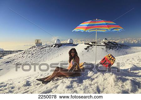 A Woman In Bikini Sitting In The Snow With Beach Umbrella With The View From Mauna Kea Observatories; Mauna Kea Hawaii United States Of America View Large Photo Image Stock Photo - A Woman In Bikini Sitting In The Snow With Beach Umbrella With The View From Mauna Kea Observatories; Mauna Kea Hawaii United States Of America. Fotosearch