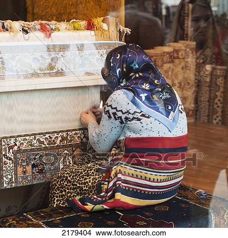 Picture - A Woman Kneeling As She Weaves On A Loom; Istanbul Turkey. Fotosearch