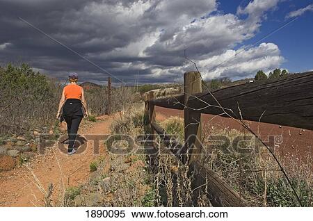 Stock Photography - A Woman On A Nature Walk Through Red Rock State Park.. Fotosearch