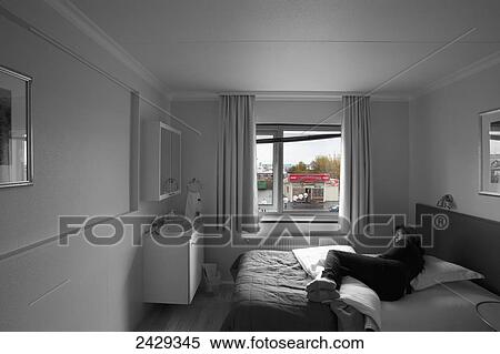 Stock Photography - A woman resting in a hotel room; Keflavik, Iceland. Fotosearch
