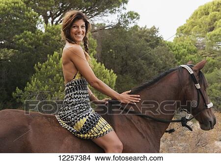 A woman riding horseback; Tarifa, Cadiz, Andalusia, Spain View Large Photo Image Picture - A woman riding horseback; Tarifa, Cadiz, Andalusia, Spain. Fotosearch