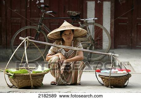 Stock Photo - A woman selling her wares outside the Katha pagoda on the Irrawaddy River, Upper Burma; Myanmar. Fotosearch
