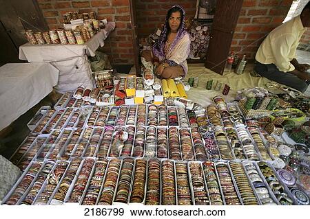 Stock Photo - A woman sells jewelry; Tamil Nadu, India. Fotosearch
