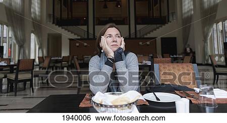 A Woman Sitting At A Restaurant Table At The Taj Hotel; Thimphu Thimphu District Bhutan View Large Photo Image Stock Photograph - A Woman Sitting At A Restaurant Table At The Taj Hotel; Thimphu Thimphu District Bhutan. Fotosearch