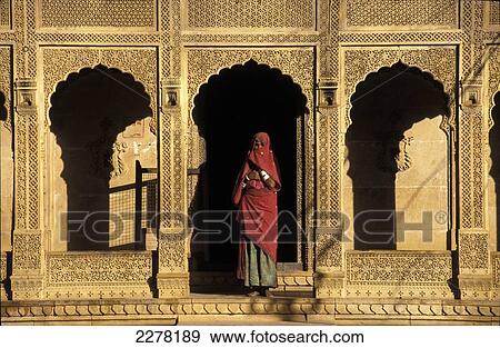 A woman standing under a gold archway; Rajasthan, India View Large Photo Image Stock Photo - A woman standing under a gold archway; Rajasthan, India. Fotosearch
