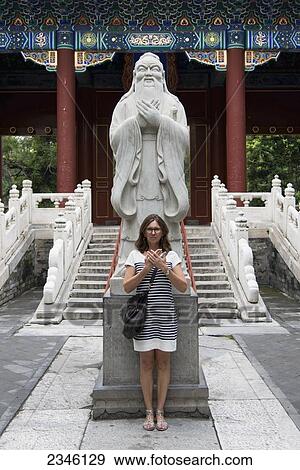 A Woman Stands In Front Of A Statue Of Confucius At The Confucius Temple; Beijing, China View Large Photo Image Stock Photo - A Woman Stands In Front Of A Statue Of Confucius At The Confucius Temple; Beijing, China. Fotosearch