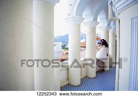 Stock Image - A woman stands in Kek Lok Si Temple; Penang, Malaysia. Fotosearch