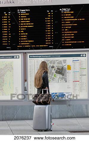 A Woman Stands With Her Luggage Looking At The Map Of Public Transportation Routes; Oslo Norway View Large Photo Image Stock Photo - A Woman Stands With Her Luggage Looking At The Map Of Public Transportation Routes; Oslo Norway. Fotosearch