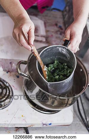 A woman stirs a pitcher of hot soy wax to prepare her handmade candles in demonstrating the step by step process for candle making; Fort McMurray, Alberta, Canada View Large Photo Image Stock Photograph - A woman stirs a pitcher of hot soy wax to prepare her handmade candles in demonstrating the step by step process for candle making; Fort McMurray, Alberta, Canada. Fotosearch
