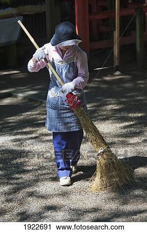 A Woman Sweeping At The Kasuga Grand Shrine; Nara, Nara Prefecture, Japan View Large Photo Image Stock Image - A Woman Sweeping At The Kasuga Grand Shrine; Nara, Nara Prefecture, Japan. Fotosearch