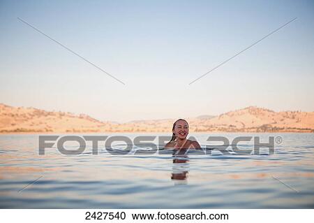 Stock Image - A woman swims in Lake Hume; Riverina, New South Wales, Australia. Fotosearch