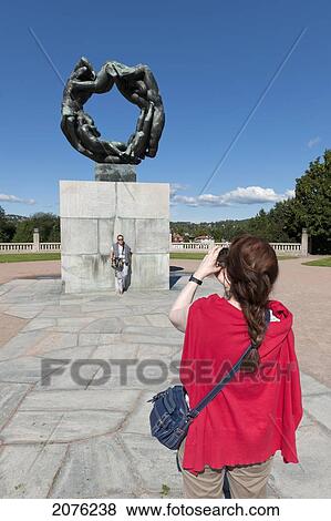 A Woman Takes A Picture Of The Wheel Of Life Sculpture In Vigeland Sculpture Park; Oslo Norway View Large Photo Image Stock Photo - A Woman Takes A Picture Of The Wheel Of Life Sculpture In Vigeland Sculpture Park; Oslo Norway. Fotosearch