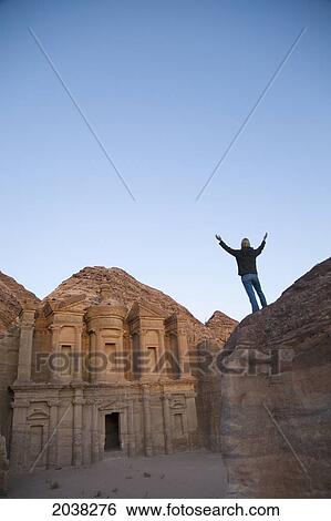 A Woman Tourist Raises Her Arms In Front Of The Nabatean Ruins Of The Monastery; Petra Jordan View Large Photo Image Stock Photograph - A Woman Tourist Raises Her Arms In Front Of The Nabatean Ruins Of The Monastery; Petra Jordan. Fotosearch
