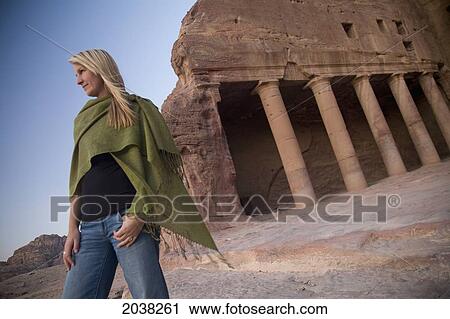 Stock Image - A Woman Tourist Visits The Nabatean Ruins; Petra Jordan. Fotosearch