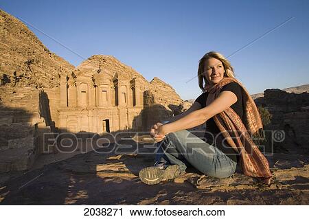 Stock Image - A Woman Tourist Visits The Nabatean Ruins Of The Monastery; Petra Jordan. Fotosearch