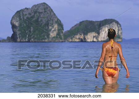 A Woman Tourist Wearing A Bikini Enjoys The Sunshine On The Tropical Island Of Koh Ngai Or Ko Ngai Near Trang; Koh Ngai Thailand View Large Photo Image Stock Image - A Woman Tourist Wearing A Bikini Enjoys The Sunshine On The Tropical Island Of Koh Ngai Or Ko Ngai Near Trang; Koh Ngai Thailand. Fotosearch