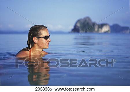 A Woman Tourist Wearing A Bikini Swims In The Water On The Tropical Island Of Koh Ngai Or Ko Ngai Near Trang; Koh Ngai Thailand View Large Photo Image Stock Photography - A Woman Tourist Wearing A Bikini Swims In The Water On The Tropical Island Of Koh Ngai Or Ko Ngai Near Trang; Koh Ngai Thailand. Fotosearch