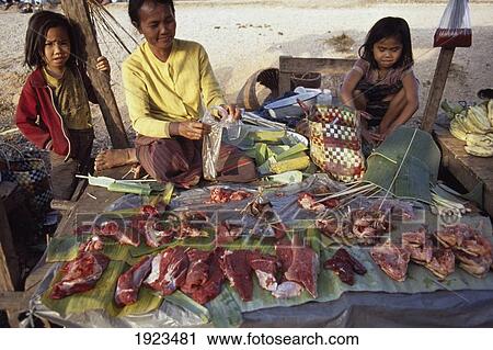 Stock Image - A Woman Vendor And Two Small Girls. Fotosearch