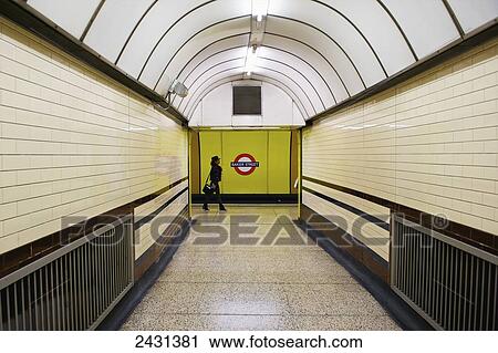 A woman walking at the end of a corridor with arched ceiling in the London Underground; London, England View Large Photo Image Stock Image - A woman walking at the end of a corridor with arched ceiling in the London Underground; London, England. Fotosearch