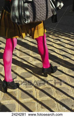 A woman walking with bright pink tights and trendy shoes, Marais district; Paris, France View Large Photo Image Stock Image - A woman walking with bright pink tights and trendy shoes, Marais district; Paris, France. Fotosearch